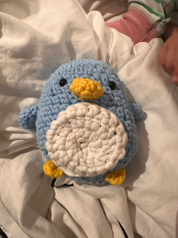 A blue crocheted penguin with baby penguin